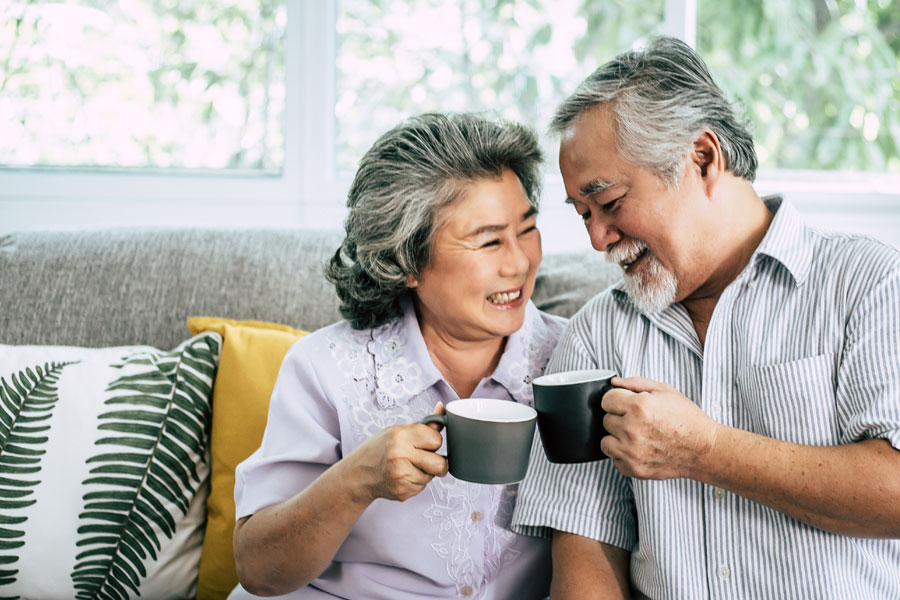 Elderly Couple Holding Cups