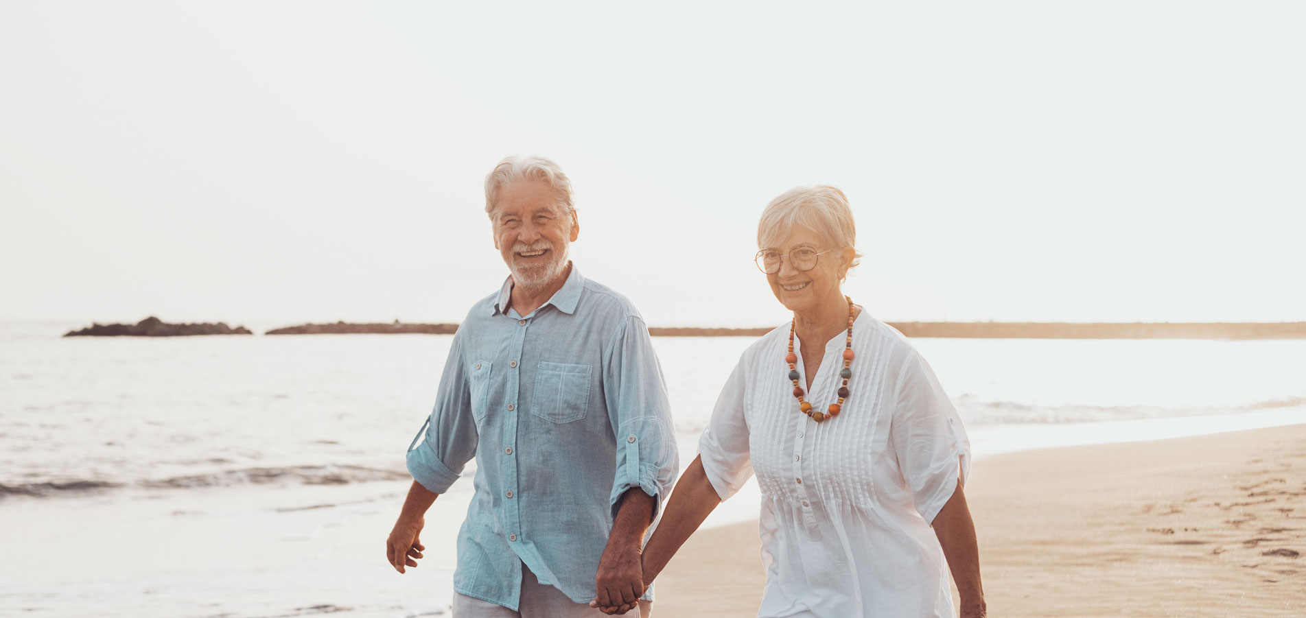 Elderly Couple Walking Beach