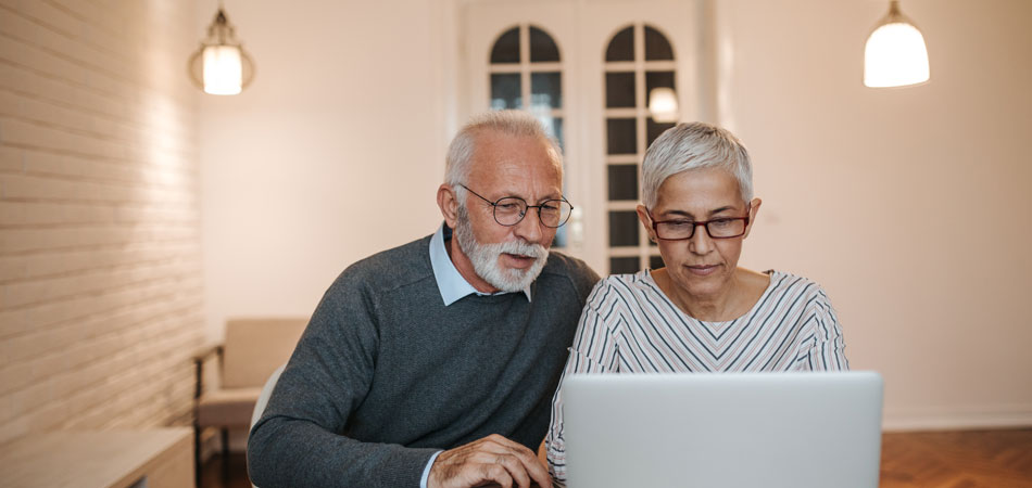 Elderly couple on laptop